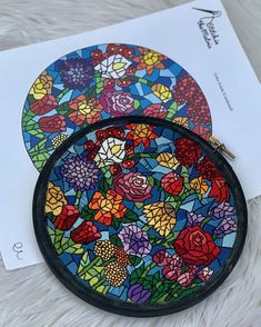 two stained glass coasters with flowers on them