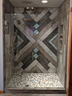 a walk in shower with wooden tiles on the walls