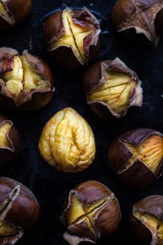 some nuts that have been peeled and are sitting on a black surface with the kernels still intact