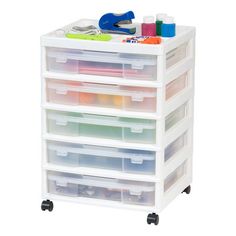 a white drawer with drawers and plastic containers on wheels for crafting, sewing or painting