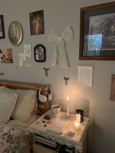 a bed room with a neatly made bed and pictures on the wall