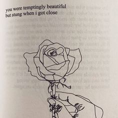 an open book with a drawing of a person holding a rose