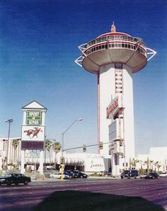 a tall white tower sitting on the side of a road