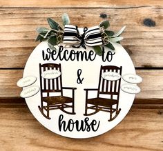 a welcome sign with two rocking chairs on the front and back of it that says, welcome to & house