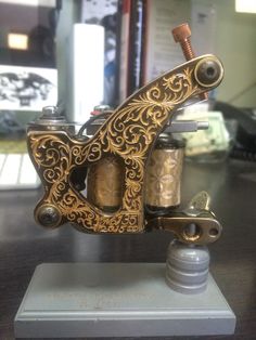 an old style tattoo machine sitting on top of a table