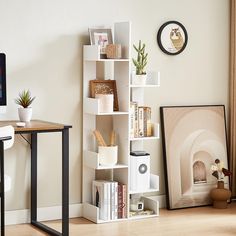 a computer desk with books and pictures on it