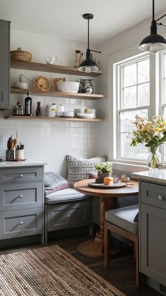 a kitchen with gray cabinets and white walls