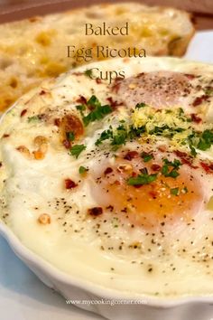 baked egg ricotta cups on a white plate with bread in the background and text overlay