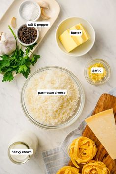 ingredients to make an appetizer laid out on a marble counter top, including butter, parmesan cheese and garlic