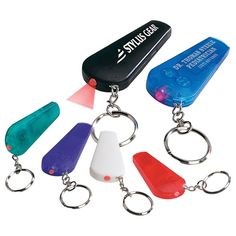 an assortment of key chains with different colored lights on each one and a plastic bottle opener in the middle