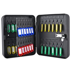 an open tool box with keys and clips in it