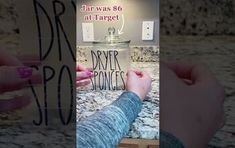 two hands holding up a sign that says dryer yoges in front of a mirror