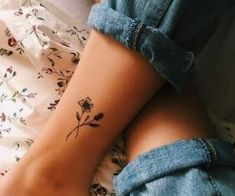 a woman's foot with a flower tattoo on it