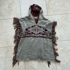 Elan Nwot Fringe Aztec Hoodie Poncho Os Colorful Is Brand New With Tags Removed. Super Comfy And Stretchy. Loose Fitting And Warm! Priced To Sell And Will Ship Out Same Day As Purchased. Open To Offers On All Items. Chm Casual Hooded Poncho For Festival, Hooded Fall Festival Poncho, Casual Hooded Poncho For Cold Weather, Gray Poncho For Cold Weather In Fall, Casual Gray Long Sleeve Poncho, One Size Winter Festival Tops, Winter Festival One Size Tops, Gray Long Sleeve Bohemian Outerwear, Aztec Poncho