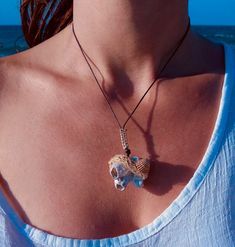 This Unique Limpet Shell Sea Rock Pendant, Ethnic Style, is handmade with love from Greece. This extraordinary summer necklace consists of a white biogenic sendimentary sea rock with two visible limpets on its surface, and it's personally collected on one of my summer strolls along my favorite beach in Greece. It's framed with a natural brown sea shell on a thick decorative linen cord and tied to a brown cotton cord adorned with a beige macrame detail and two wooden beads at the edge. One-Of-a-K Bohemian Beaded Pendant Necklace For Beach, Beach Style Amulet Pendant Jewelry, Natural Shell Necklaces For Festivals, Natural Shell Necklaces For Festival, Bohemian Natural Shell Necklace For Festival, Handmade Natural Shell Necklace For Gift, Handmade White Crystal Necklace For Beach, Bohemian Pendant Necklaces For Beach, Handmade Natural Color Necklace For Vacation