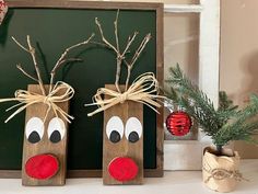 two wooden reindeers with noses tied to them