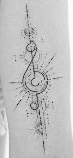 a black and white photo of a music note tattoo