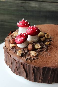 a chocolate cake topped with red mushrooms and nuts