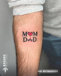 a man with a tattoo on his arm that says, mom dad and has a heart in it