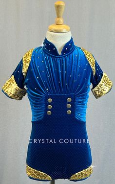 Blue velvet biketard has ruched top with short sleeves. Gold zsa zsa details on cuffs, shoulders, and leg opening. Six gold buttons on front of bodice. Bottom portion of biketard has Blue sequins. Stand collar and keyhole opening in back. 1.5 Gross of Dark Indigo AB 20ss Rhinestones! **Costume in image is a YM, Photographed on a YM/YL Mannequin with Measurements of: Bust 27", Waist 24", Hip 27", Girth 47" Royal Blue Fitted Short Sleeve Top, Trio Costumes, Sequin Jewelry, Costumes Couture, Zsa Zsa, Sequin Appliques, Tutu Costumes, Group Costumes, Ruched Top