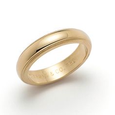 a gold wedding ring with engraved engraving on the outside and inside, set in 18k yellow gold