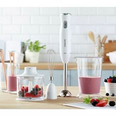 the blender is full of berries, raspberries, and other ingredients for making smoothies