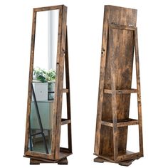 a tall wooden mirror sitting on top of a shelf next to a plant in a pot