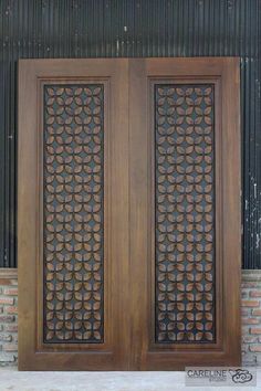 two wooden doors with decorative designs on them