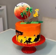 a birthday cake decorated with the lion king and jungle animals on it's side