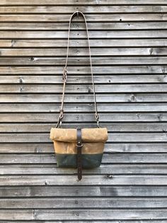 This day bag / satchel is your perfect companion for the days when you only need some necessities to take with you. The day bag is made in heavy weight waxed canvas in the color spice and forest green , with roll to close top, with snap and strap closing. Made it with a double layered bottom, for extra durability and strength. (in forest green waxed canvas ) Phone pocket on the backside closing with pouch button. With adjustable and detachable shoulder strap in vegetable tanned leather Fully lin Brown Duck Canvas Shoulder Bag With Adjustable Strap, Brown Waxed Canvas Shoulder Bag For Outdoor, Outdoor Waxed Finish Crossbody Shoulder Bag, Outdoor Shoulder Bag With Waxed Finish, Waxed Canvas Backpack Shoulder Bag For Outdoor, Waxed Canvas Shoulder Bag For Outdoor, Waxed Canvas Backpack With Waxed Finish, Outdoor Satchel Bag With Canvas Lining, Brown Canvas Satchel With Waxed Finish