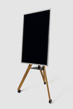 an easel with a black board on it's legs is shown in front of a white background