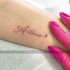 a woman's arm with the word antonio written in cursive writing on it