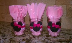 three plastic utensils with minnie mouse ears and bows on them are lined up next to each other