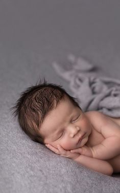 a baby is laying down on a blanket