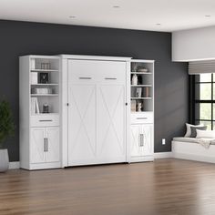 a living room with white furniture and wood floors