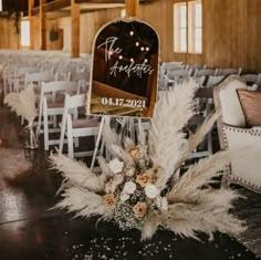 the chairs are set up for an event with flowers and pamonini on them