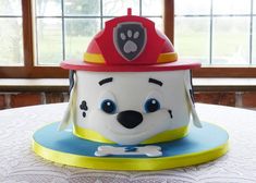 a cake shaped like a fireman's hat on top of a table