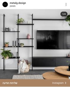 a living room filled with furniture and a flat screen tv mounted on a wall next to a wooden table