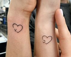 two people with matching tattoos on their arms