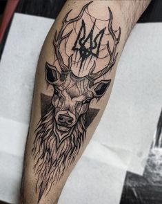 a man's arm with a deer head and numbers tattooed on the upper part of it