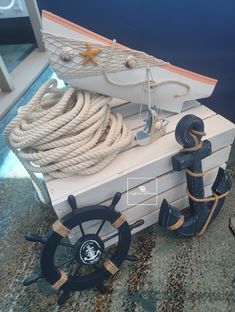 there is a small boat made out of rope and other items on the floor next to it