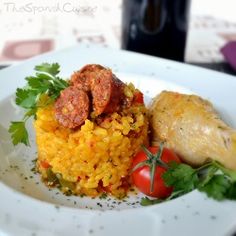 a white plate topped with rice and meat