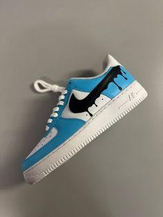 Introducing our custom hand-painted Nike Air Force 1's, featuring a trendy baby blue color with a bold black Nike swoosh design. These one-of-a-kind kicks are perfect for making a statement and adding a touch of individuality to your wardrobe. Don't miss out on owning a piece of wearable art that is both stylish and durable. Painted Nike Air Force, Painted Nikes, Nike Air Force 1s, Baby Blue Colour, Custom Hand Painted, Nike Swoosh, Trendy Baby, Black Nike, Bold Black