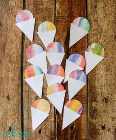 paper hearts are arranged on a wooden surface