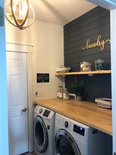 a washer and dryer in a laundry room next to a door with the word laundry written on it