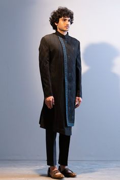 Black achkan style sherwani with floral embroidered motifs, highlighted with dabka work and pintuck asymmetric panel. Paired with pant.
Component: 2
Embroidered
Neckline: Band
Sleeve Length: Full
Fabric: Slub Silk, Cotton Silk
Color: Black
Asymmetric panel - Aza Fashions Jatin Malik, Dabka Work, Embroidered Sherwani, Embroidered Motifs, Embroidered Neckline, Pin Tucks, Embroidered Silk, Cotton Silk, Aza Fashion