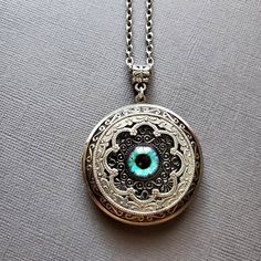 Large Locket Dragon Eye Necklace ☻Locket ~ Large, Decoratively Styled ~ Measures 1.77 inches round See Photos for size comparison against American quarter Chain: ~ Silver Plated YOU CHOOSE YOUR CHAIN LENGTH during checkout ☻More Lockets Here: https://www.etsy.com/shop/FashionCrashJewelry/search?search_query=lockets&order=date_desc&view_type=gallery&ref=shop_search ☻Link to The ENTIRE SHOP: https://www.etsy.com/shop/FashionCrashJewelry?ref=shopsection_shophome_leftnav&ga_search_qu Adjustable Bohemian Jewelry Keepsake, Bohemian Adjustable Jewelry For Keepsake, Spiritual Nickel-free Round Disc Jewelry, Bohemian Handmade Jewelry For Keepsake, Handmade Bohemian Keepsake Jewelry, Bohemian Handmade Keepsake Jewelry, Nickel-free Round Spiritual Jewelry, Vintage Locket Jewelry For Festivals, Antique Nickel-free Jewelry For Festivals