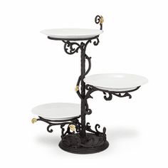 three tiered cake stand with white plates on it