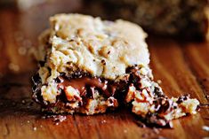 chocolate chip cookie bars on a cutting board with one cut in half to show the filling