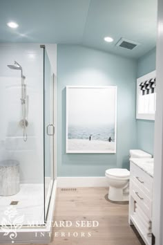 a bathroom with blue walls and white fixtures